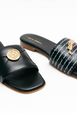 Load image into Gallery viewer, Black slide sandals with gold accents on a white background
