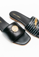 Load image into Gallery viewer, Black slides with gold accents on a white background
