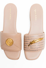 Load image into Gallery viewer, Pair of beige slides with gold accents on a white background
